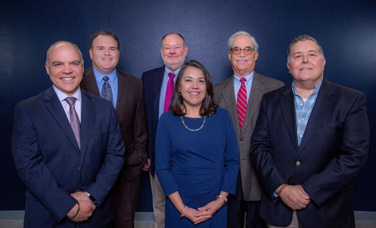 High Ridge team in suits in front of a blue background